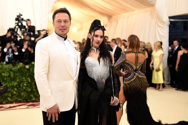 Elon Musk with his girlfriend Grimes. 
(Photo by Jason Kempin/Getty Images)