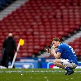 An emotional Liam Craig speaks to his family on his mobile phone following St Johnstone's Betfred Cup win over Livingston  (Photo by Craig Williamson / SNS Group)