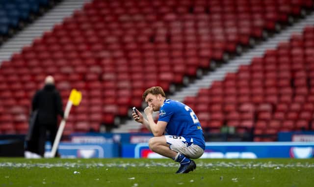 An emotional Liam Craig speaks to his family on his mobile phone following St Johnstone's Betfred Cup win over Livingston  (Photo by Craig Williamson / SNS Group)