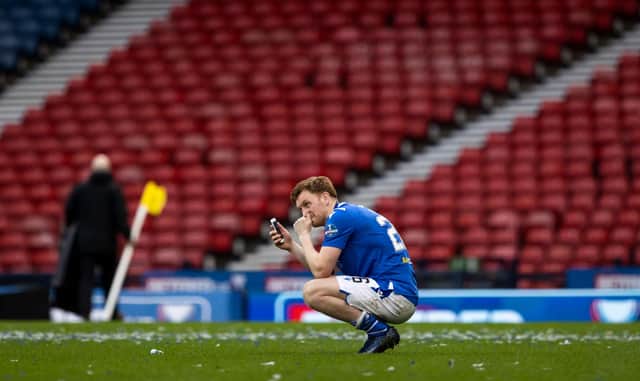 An emotional Liam Craig speaks to his family on his mobile phone following St Johnstone's Betfred Cup win over Livingston (Photo by Craig Williamson / SNS Group)