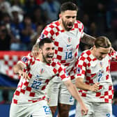 Celtic defender Josip Juranovic celebrates with Croatia team-mates Marko Livaja and Lovro Majer after the penalty shoot-out win over Japan in the last 16 of the World Cup. (Photo by JEWEL SAMAD/AFP via Getty Images)