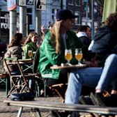 Customers drink and eat at a terrace in the centre of Amsterdam.