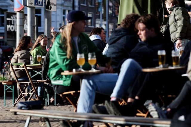 Customers drink and eat at a terrace in the centre of Amsterdam.