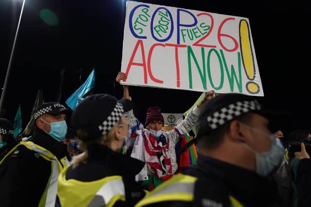 Police officers with protesters at the entrance of the Scottish Event Campus (SEC) in Glasgow where the Cop26 summit is being held.