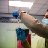 A dose of the Oxford/AstraZeneca coronavirus vaccine is drawn into a syringe (Picture: Jacob King/PA Wire)