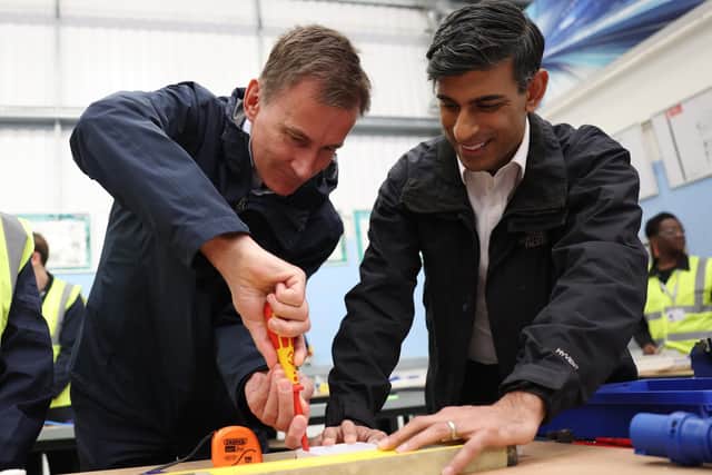 Chancellor Jeremy Hunt, seen doing electrical work at a college in north London with Rishi Sunak, appears to have little room to manoeuvre on tax cuts (Picture: Daniel Leal/WPA pool/Getty Images)