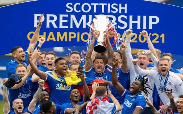 Jubilant Rangers players celebrate as captain James Tavernier holds up the Premiership trophy. (Photo by Craig Williamson / SNS Group)