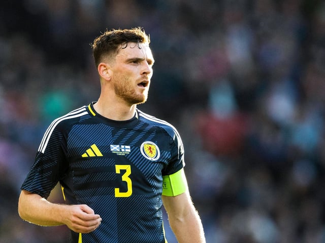 The Liverpool defender lines up at left wing-back and captains Scotland for a record 50th time as he earns cap number 72.