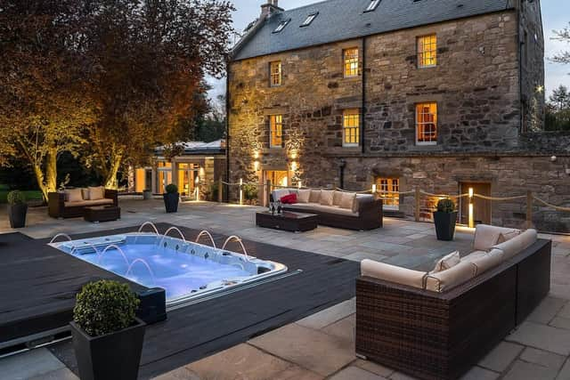 The Old Millhouse seen from the rear with its hydro pool and terrace.