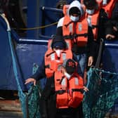 A group of migrants disembark from a UK Border Force boat at the port of Dover having being picked up crossing the English Channel from France.