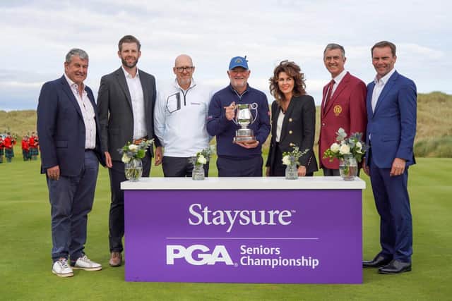Peter Baker shows off the trophy flanked by  Phil Harrison, CEO Legends Tour, Ryan Howsam, Staysure Group Chairman & Legends Tour Co-owner, Eric Trump, Executive Vice President of Trump Organisation, Sarah Malone, Executive Vice President of Trump International, Tim Rouse, Captain of The PGA of GB&I and Rob Maxfield, CEO of The PGA of GB&I. Picture: Getty Images.