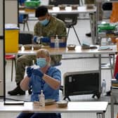 A nurse with a vial of vaccine at the vaccination centre at Ravenscraig Regional Sports Facility in Motherwell, Scotland. Picture date: Friday June 11, 2021.