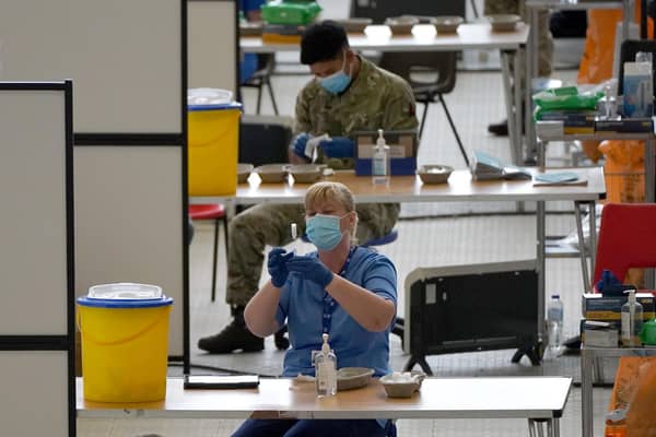 A nurse with a vial of vaccine at the vaccination centre at Ravenscraig Regional Sports Facility in Motherwell, Scotland. Picture date: Friday June 11, 2021.