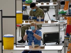 A nurse with a vial of vaccine at the vaccination centre at Ravenscraig Regional Sports Facility in Motherwell, Scotland. Picture date: Friday June 11, 2021.