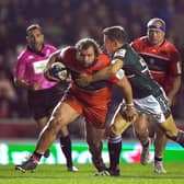 Edinburgh's Pierre Schoeman attempts to get past Leicester Tiger's Jimmy Gopperth (right) during the match at Welford Road on Friday.