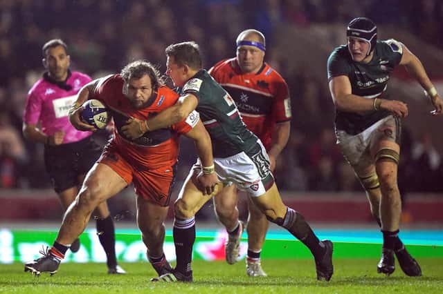 Edinburgh's Pierre Schoeman attempts to get past Leicester Tiger's Jimmy Gopperth (right) during the match at Welford Road on Friday.