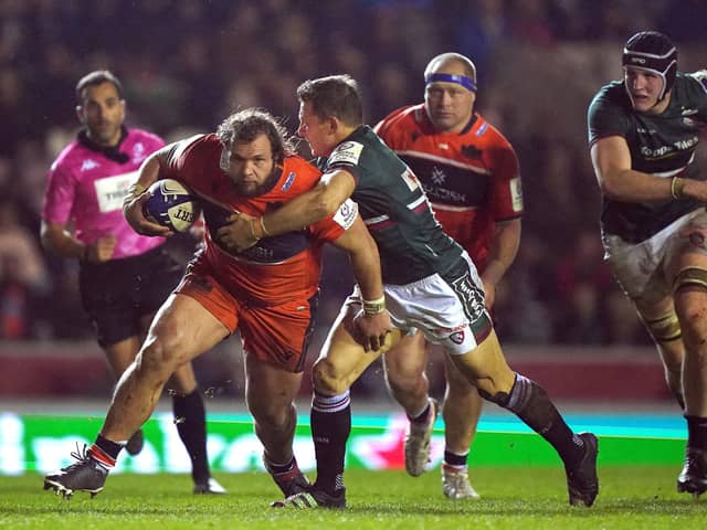 Edinburgh's Pierre Schoeman attempts to get past Leicester Tiger's Jimmy Gopperth (right) during the match at Welford Road on Friday.