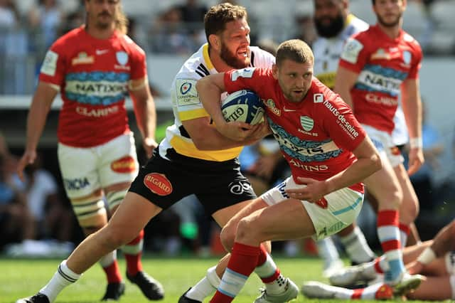 Finn Russell of Racing 92 is tackled by La Rochelle's Tawara Kerr-Barlow during the Heineken Champions Cup semi-final. (Photo by David Rogers/Getty Images)