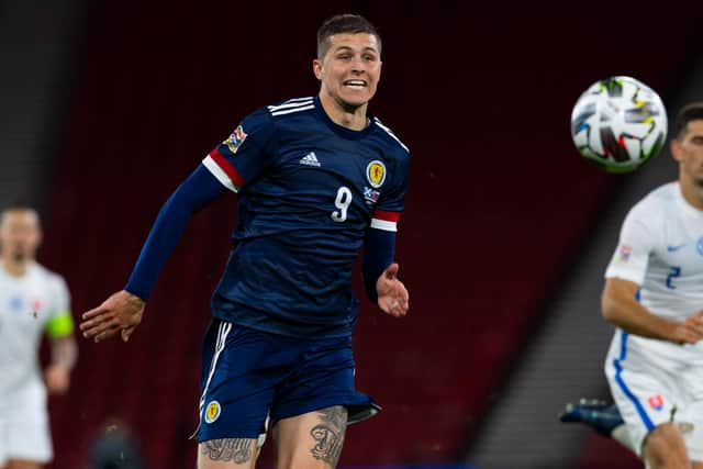 Lyndon Dykes will lead Scotland's line in Serbia.