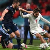 Jack Grealish of England runs with the ball whilst under pressure from Stephen O'Donnell and Che Adams of Scotland during the UEFA Euro 2020 Championship Group D match between England and Scotland at Wembley Stadium on June 18 picture: Andy Rain/Getty Images