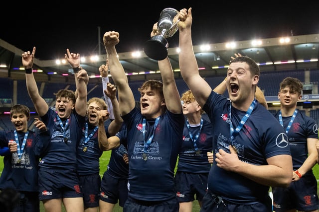 Merchiston's players celebrate with the trophy