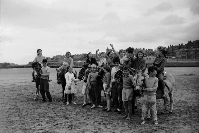 Tourists enjoying the heatave of summer 1961 with the donkeys on St Andrews Beach.