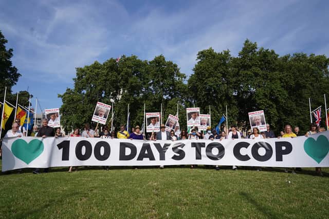 Campaigners hold a banner during a demonstration organised by the Climate Coalition in Parliament Square, London, to mark 100 days to go until the Cop26 climate summit in Glasgow.