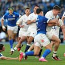 Tommy Freeman of England is held by Tommaso Memoncello during their narrow win over Italy.