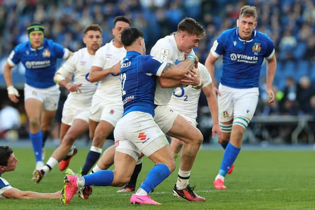 Tommy Freeman of England is held by Tommaso Memoncello during their narrow win over Italy.