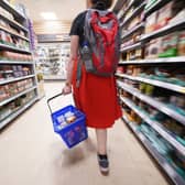 A shopper walking through the aisle of a Tesco supermarket. Picture: Yui Mok/PA Wire