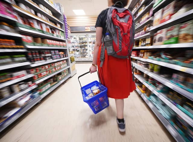 A shopper walking through the aisle of a Tesco supermarket. Picture: Yui Mok/PA Wire