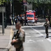 French police officers stand next to an emergency truck in Annecy, central-eastern France following a mass stabbing in the French Alpine town. Picture: Olivier Chassingnole/AFP via Getty Images