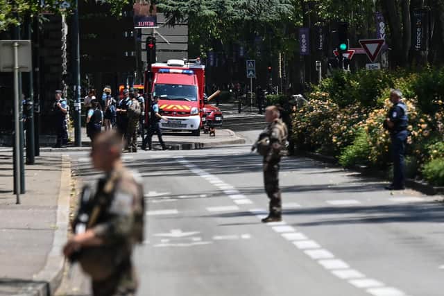 French police officers stand next to an emergency truck in Annecy, central-eastern France following a mass stabbing in the French Alpine town. Picture: Olivier Chassingnole/AFP via Getty Images