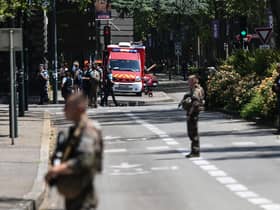 French police officers stand next to an emergency truck in Annecy, central-eastern France following a mass stabbing in the French Alpine town. Picture: Olivier Chassingnole/AFP via Getty Images