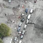 In this image released by the Police Press Service, the view from a drone shows the site of a Russian rocket attack in Zaporizhzhia, Ukraine, Friday, Sept. 30, 2022. A Russian strike on the Ukrainian city of Zaporizhzhia killed at least 23 people and wounded dozens, an official said Friday, just hours before Moscow planned to annex more of Ukraine in an escalation of the seven-month war. (Ukrainian Police Press Office via AP)