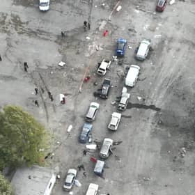 In this image released by the Police Press Service, the view from a drone shows the site of a Russian rocket attack in Zaporizhzhia, Ukraine, Friday, Sept. 30, 2022. A Russian strike on the Ukrainian city of Zaporizhzhia killed at least 23 people and wounded dozens, an official said Friday, just hours before Moscow planned to annex more of Ukraine in an escalation of the seven-month war. (Ukrainian Police Press Office via AP)