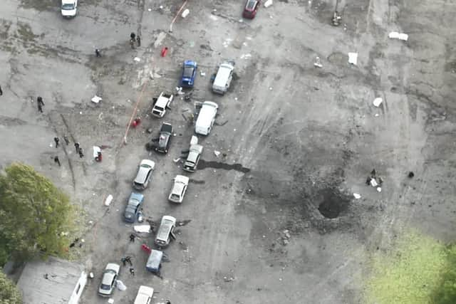 In this image released by the Police Press Service, the view from a drone shows the site of a Russian rocket attack in Zaporizhzhia, Ukraine, Friday, Sept. 30, 2022. A Russian strike on the Ukrainian city of Zaporizhzhia killed at least 23 people and wounded dozens, an official said Friday, just hours before Moscow planned to annex more of Ukraine in an escalation of the seven-month war. (Ukrainian Police Press Office via AP)