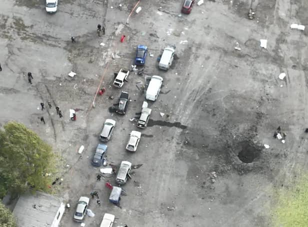 In this image released by the Police Press Service, the view from a drone shows the site of a Russian rocket attack in Zaporizhzhia, Ukraine, Friday, Sept. 30, 2022. A Russian strike on the Ukrainian city of Zaporizhzhia killed at least 23 people and wounded dozens, an official said Friday, just hours before Moscow planned to annex more of Ukraine in an escalation of the seven-month war. (Ukrainian Police Press Office via AP)