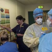 Doctors and nurses prepare to enter the Covid ward putting on the PPE safety equipment at the Edinburgh Royal Infirmary
