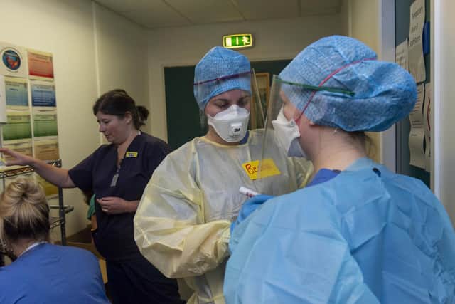 Doctors and nurses prepare to enter the Covid ward putting on the PPE safety equipment at the Edinburgh Royal Infirmary