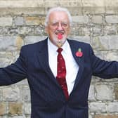 Bernard Cribbins poses with his Officer of the British Empire (OBE) medal after receiving it during an Investiture ceremony with the Princess Anne at Windsor Castle in 2011.