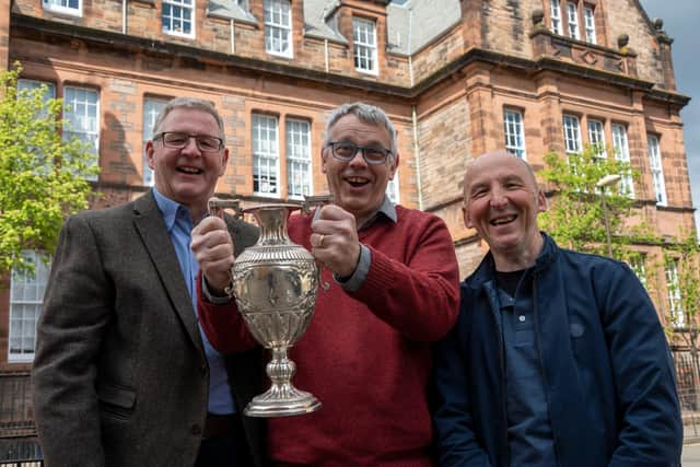 Goalkeeper David Larter, team captain David Graham and goal scorer Stuart Smith are reunited with the coveted school board cup trophy.