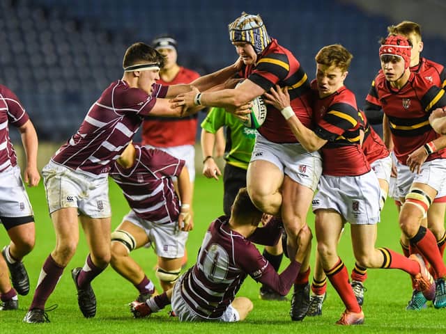 Stewart Melville’s Mikey Jones, now a pro with Edinburgh Rugby, is tackled during the Boys School Under 18 Cup Final against George Watson's College in December 2019. (Photo by Paul Devlin / SNS Group / SRU)