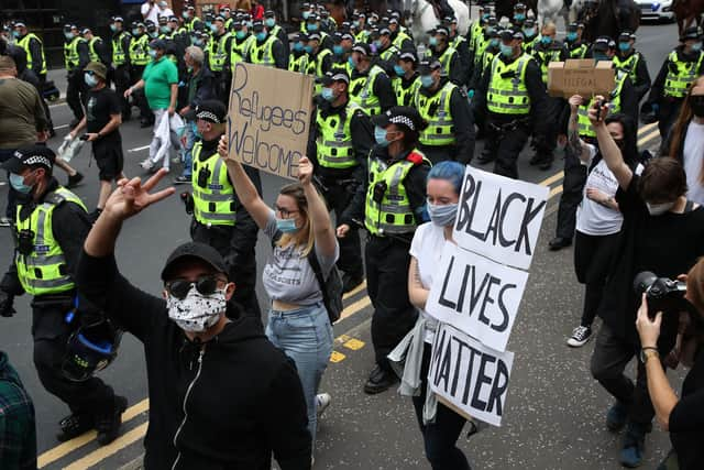 Protesters are escorted from George Square in Glasgow city centre after a Glasgow Says No to Racism event aimed at "sending a positive anti-racist message from Glasgow's George Square to the world on World Refugee Day".