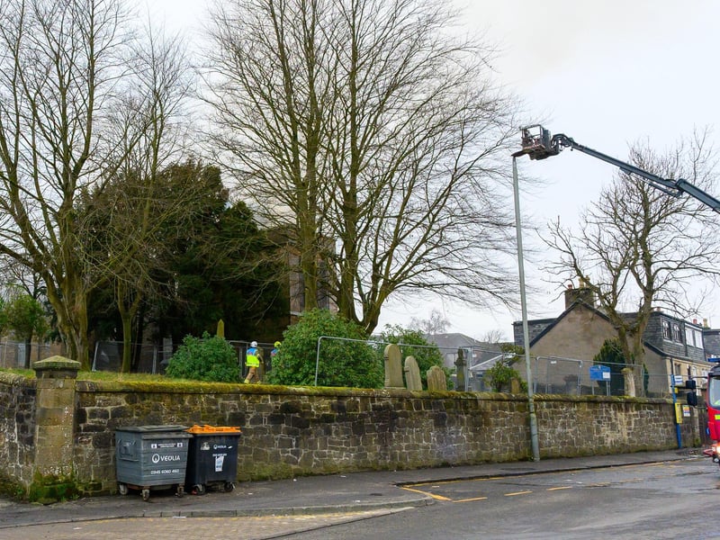 Firefighters in the graveyard that surrounds the church in Glasgow Road.