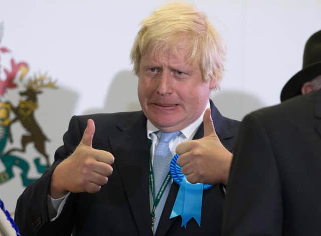 Boris Johnson may wear a blue rosette but he is not actually a real conservative (Picture: Matt Cardy/Getty Images)