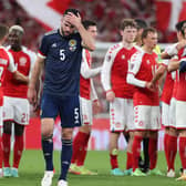 Grant Hanley, seen here after the 2-0 defeat to Denmark in Copenhagen, was booked in Scotland's last outing against Austria. The defender misses Saturday's World Cup qualifier with Israel due to suspension. (Photo by Alan Harvey / SNS Group)