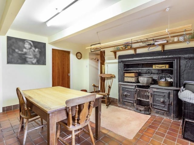 Utility room with original cast iron open range, twin Belfast sinks and inter-connecting laundry and store rooms.