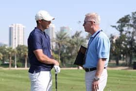 Rory McIlroy chats with DP World Tour chief executive Keith Pelley on the driving range prior to the Hero Dubai Desert Classic at Emirates Golf Club. Picture: Richard Heathcote/Getty Images.