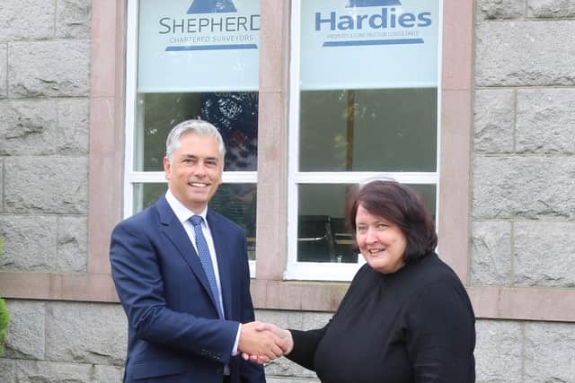 Danny McArthur and Shirley Thomson shake hands on the deal.
